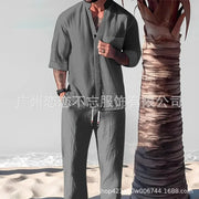 Men's summer casual cotton linen two-piece set with V-neck and loose fit pants on the beach.