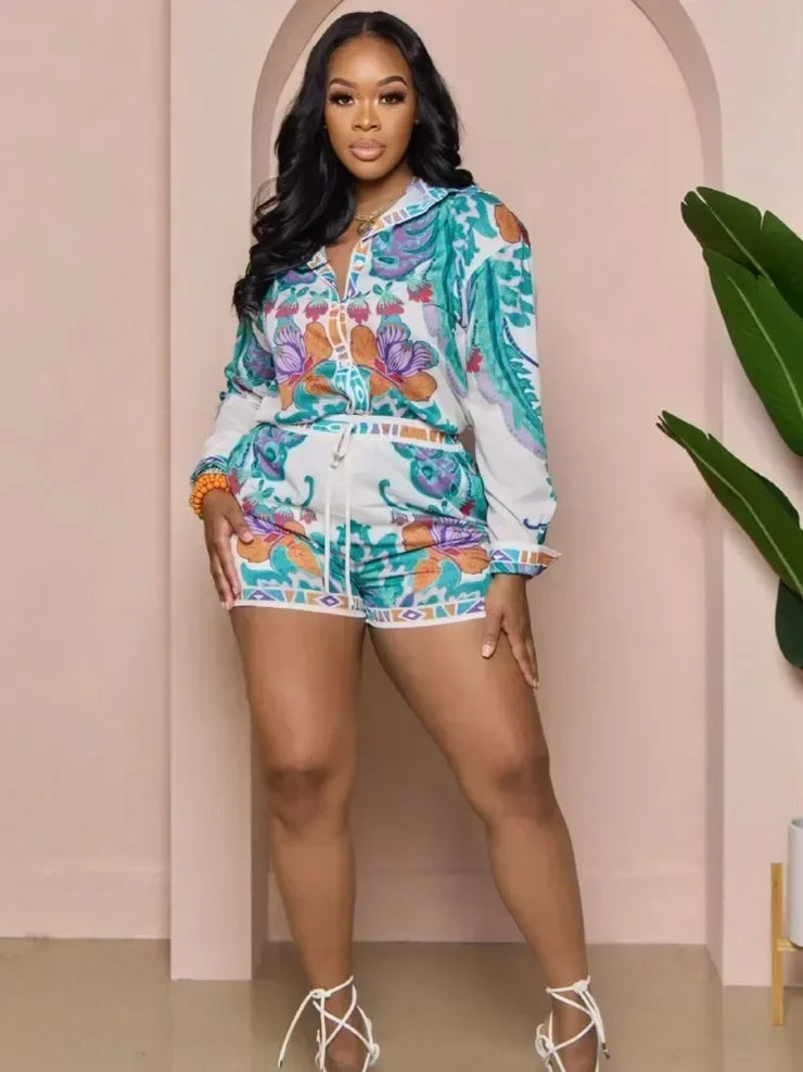 Casual two-piece set with floral print long sleeve shirt and elastic waist shorts for women, perfect for spring and summer.